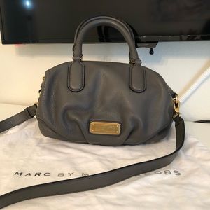 Marc Jacob grey pebble leather top handle bag with antique gold tone hardware.